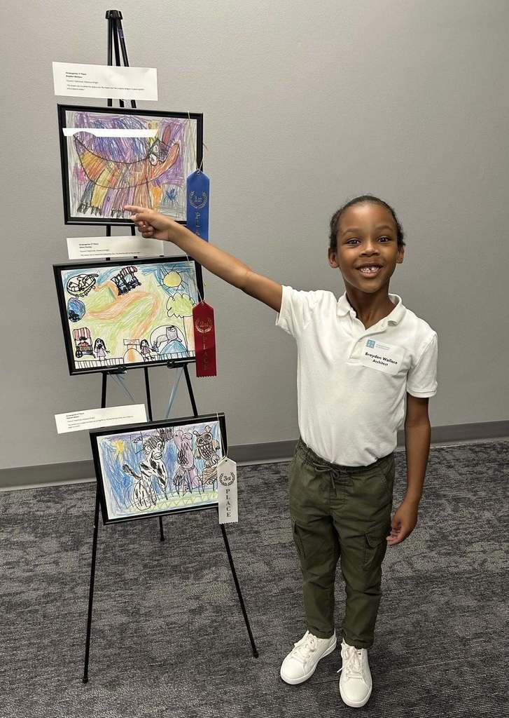 Student pointing to artwork during dreamARCHITECTURE reception