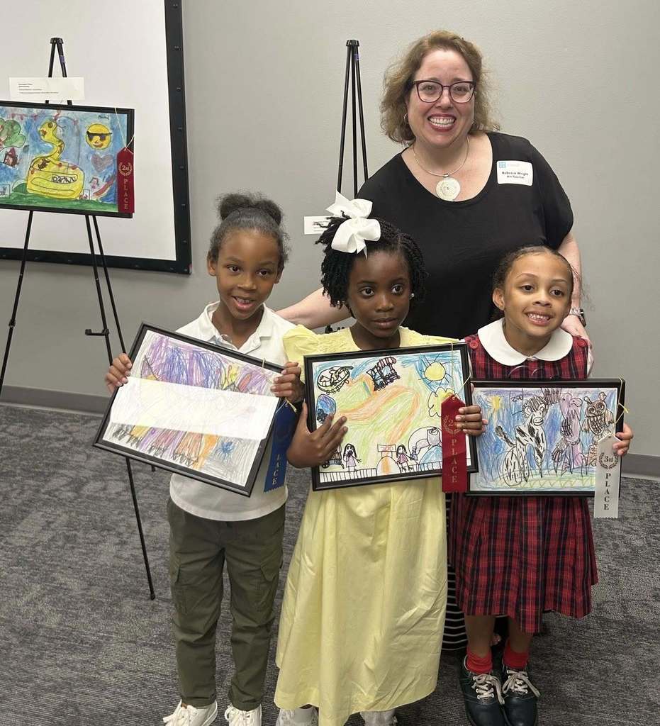 Students holding artwork during dreamARCHITECTURE reception