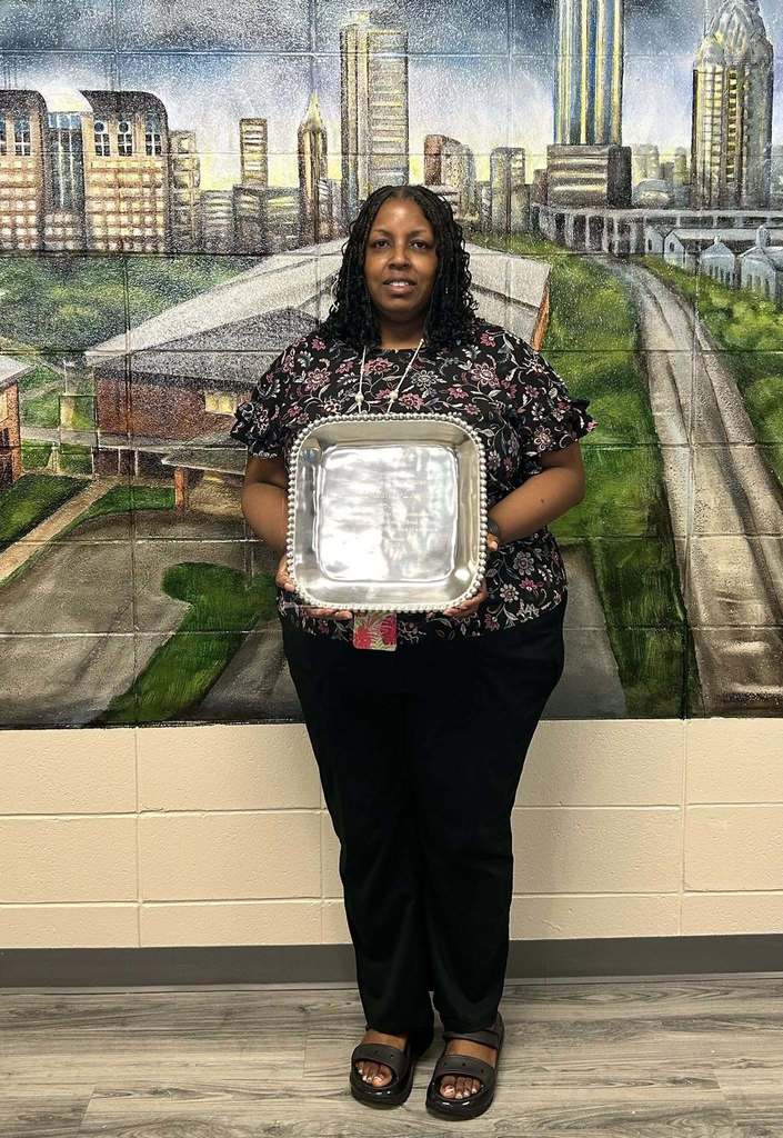 Laronda Raines-Langham (30 years) holding retirement placque