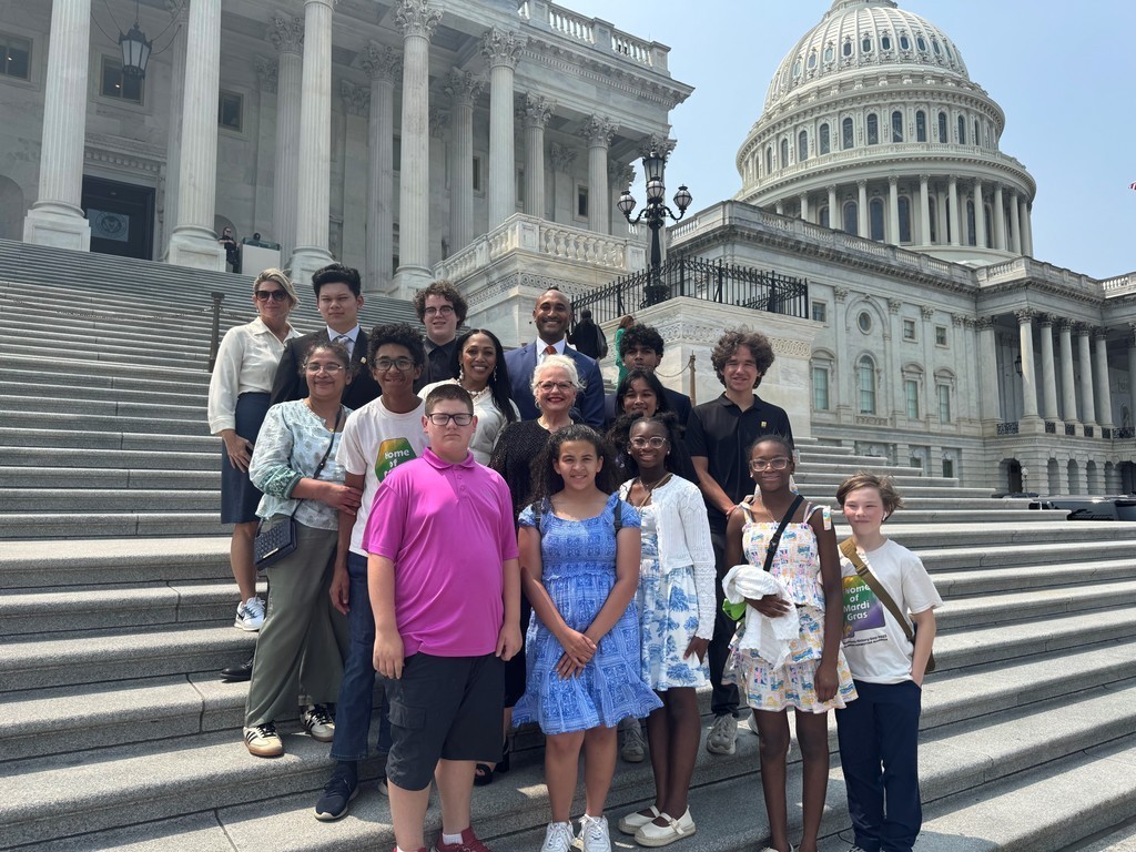 A group of Davidson High students stand with U.S. Rep. Shomari Figures on the steps of the U.S. Capitol.