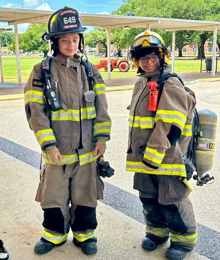 Two students dressed in firefighters' gear