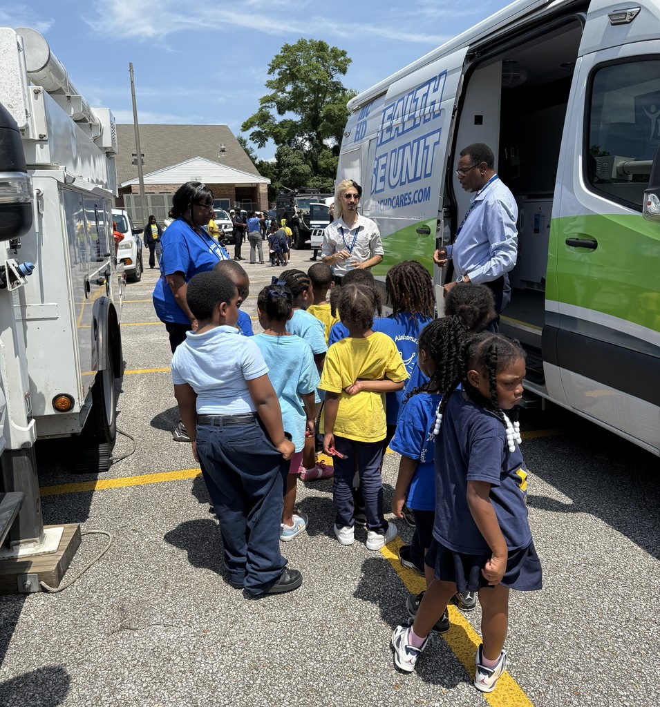 A representative of the Mobile County Health Department shows students his truck