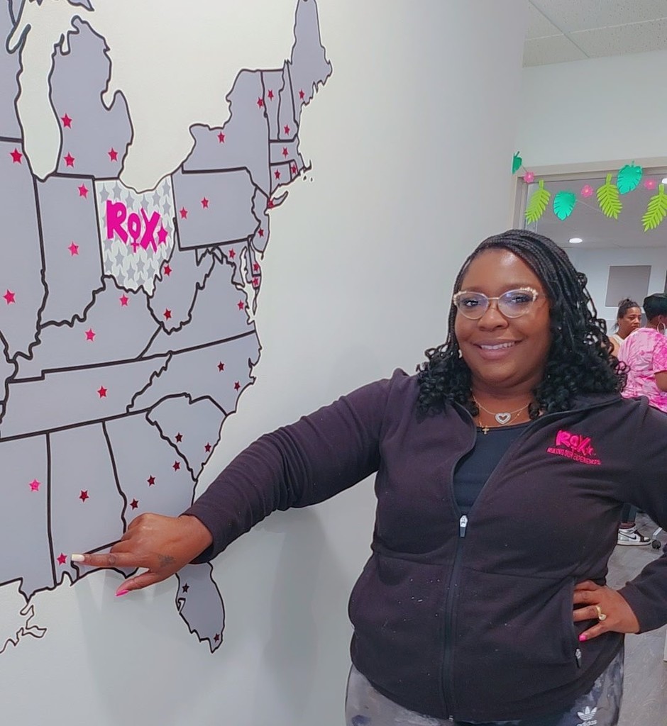 Brittnay Powe-Inge points to a star representing Mobile, Alabama, on a map of the United States