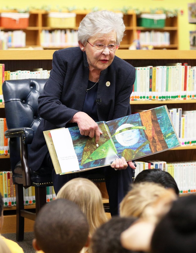 Alabama Governor Kay Ivey reads a book to a room of school children