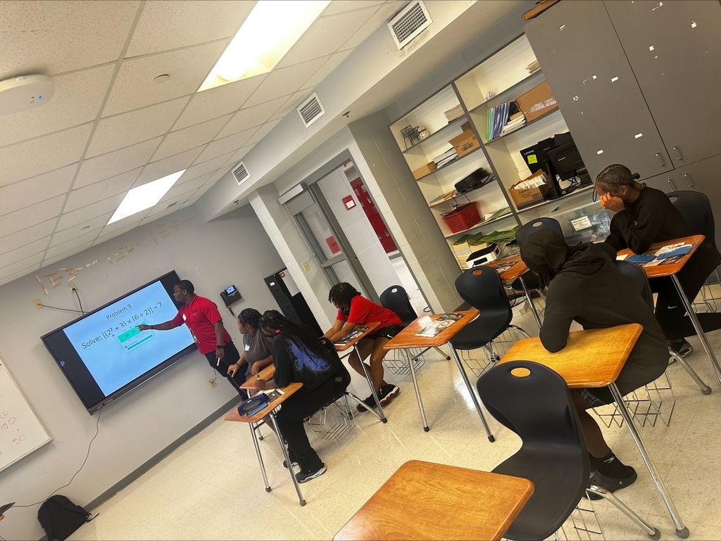 Teacher engaging with students during a brief lesson.