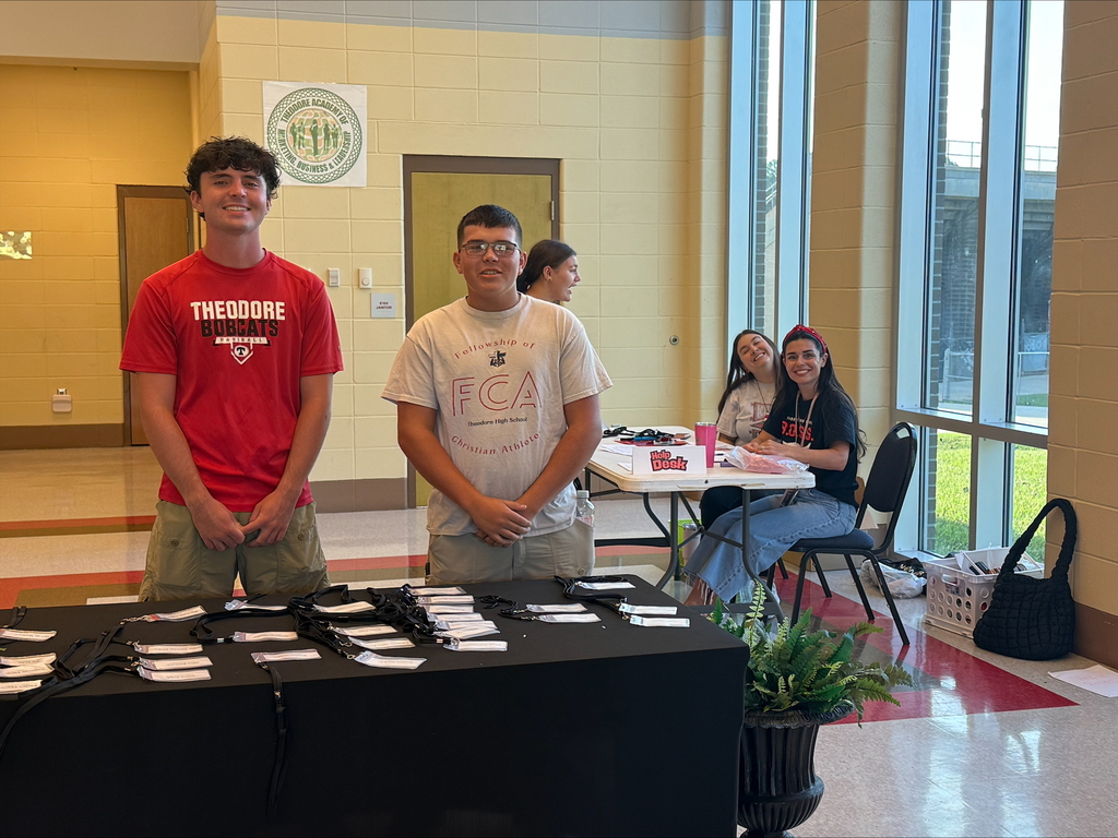 Welcoming students to Bobcat Camp and giving out name badges.