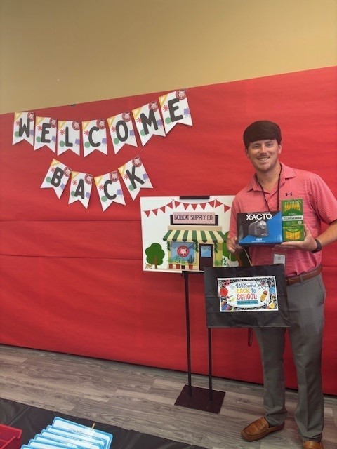 Mr. Newberry,  new to Theodore this year, with items he got from the BCS.