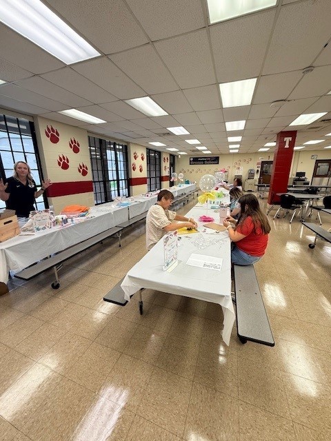 Teachers hard at work creating colorful clipboards!