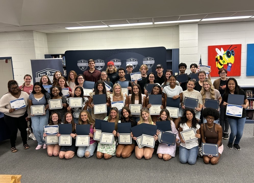 A group photo of Baker High School's AP scholars, holding their certificates