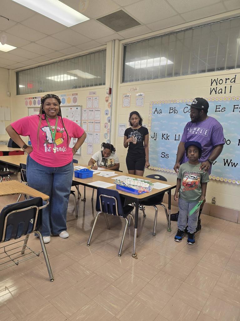 Ms. Joseph with a parent and students during Meet the Teacher at John Will School