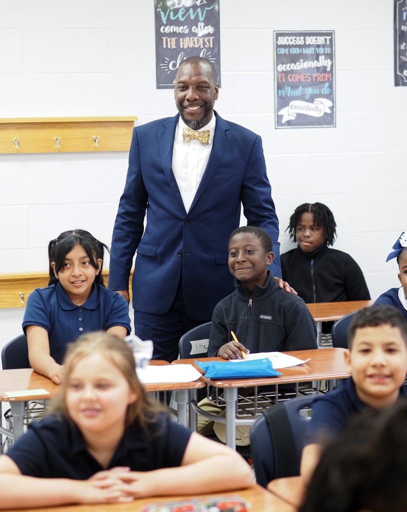 Superintendent Chresal Threadgill stands behind a classroom of students