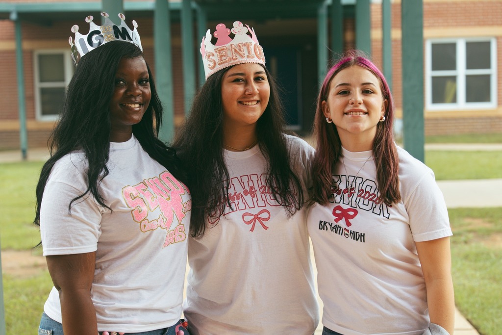 Three girls wearing makeshift tiaras and shirts that read "Senior"