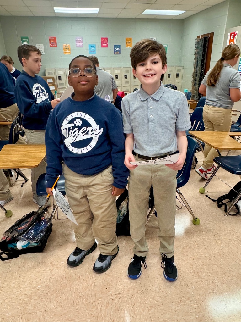Students working in a classroom, smiling