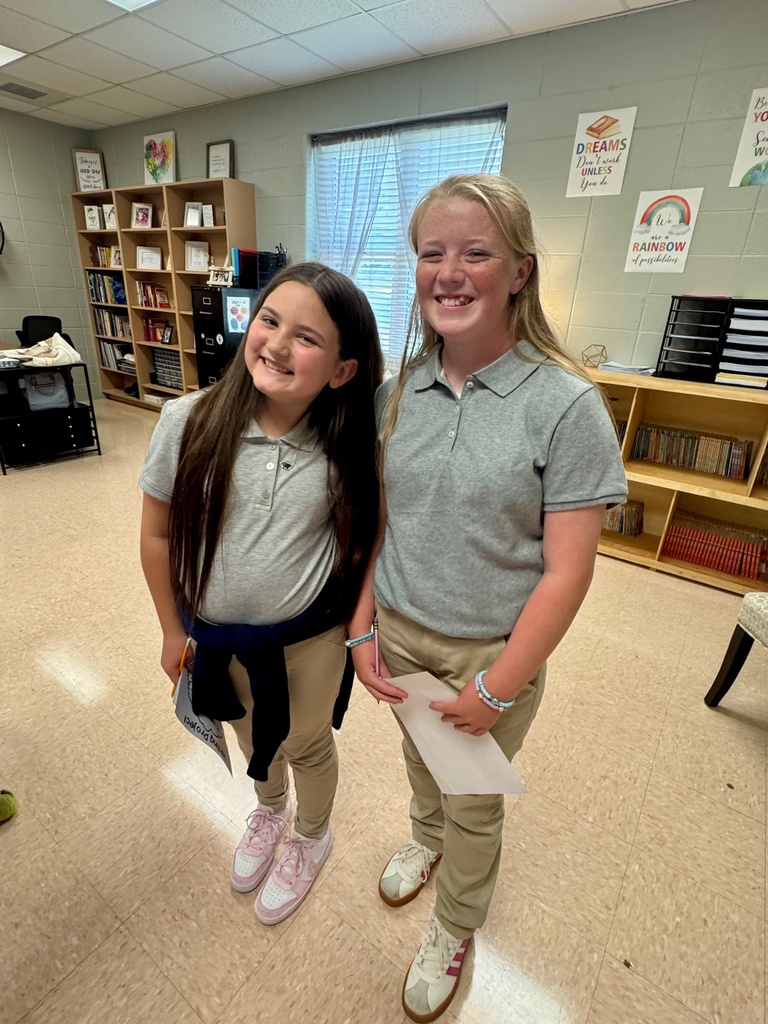 Students smiling in a classroom
