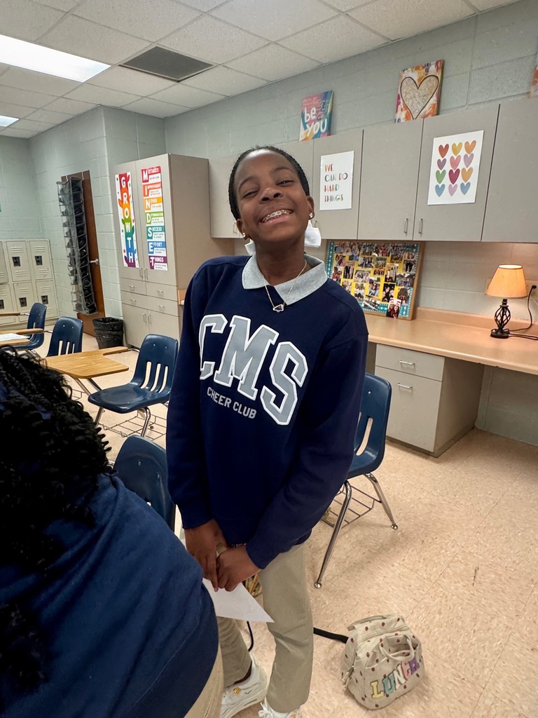 Student smiling in a classroom