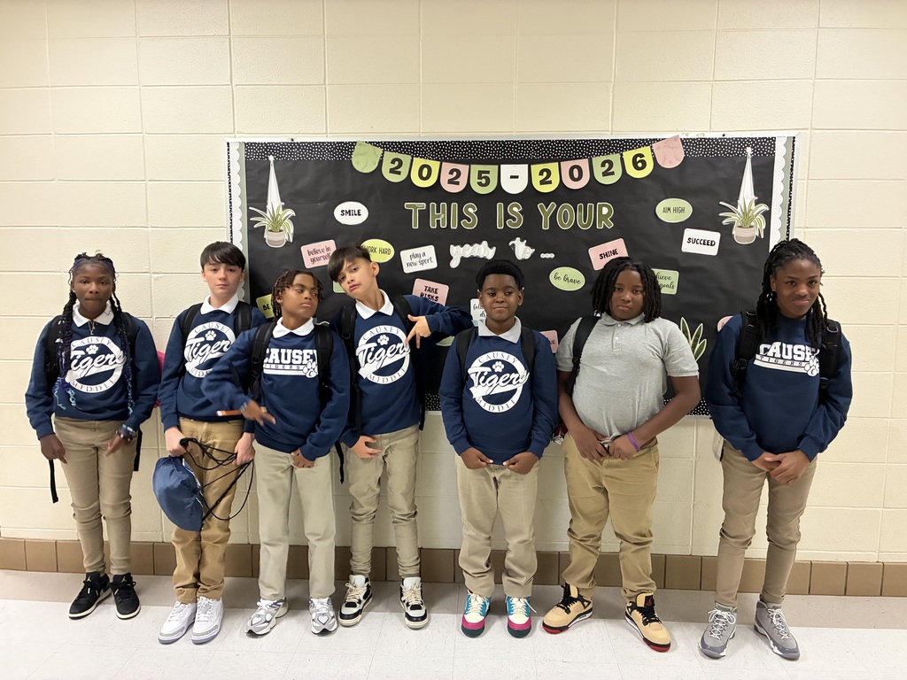 Group of students posing in a school hallway