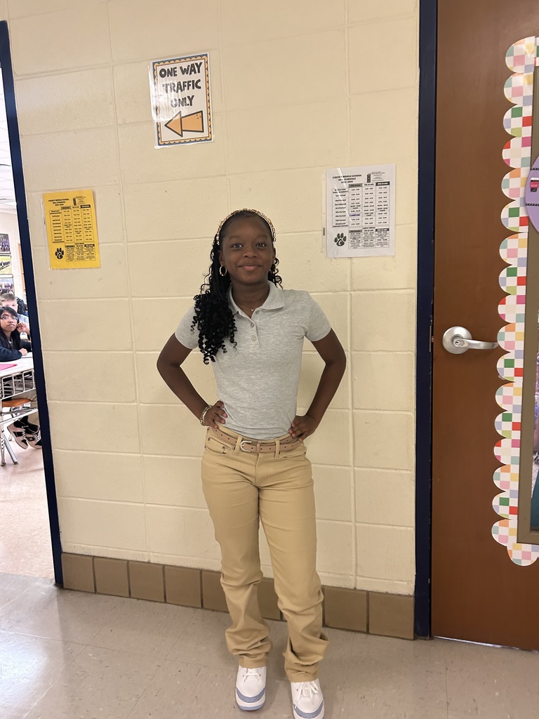 Girl posing for a picture in a hallway