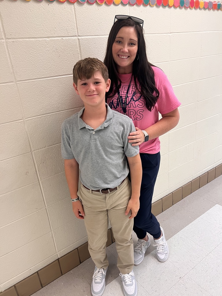 Woman and boy posing in a hallway