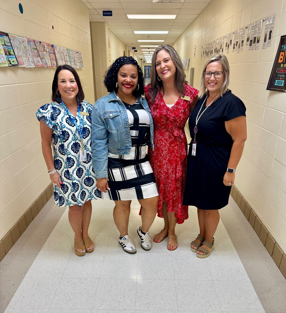 4 women posing in a school hallway
