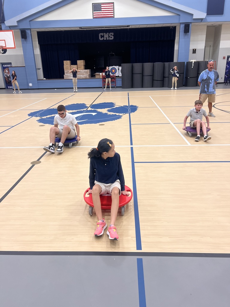 Students in gym on scooters