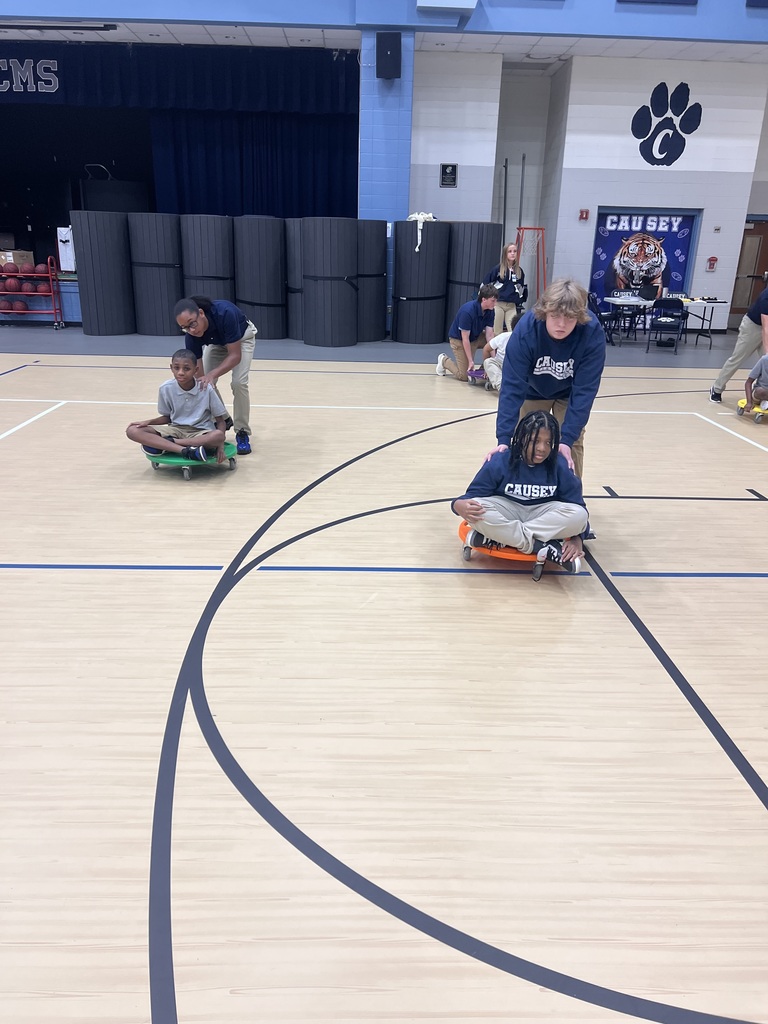 Students helping others on scooters