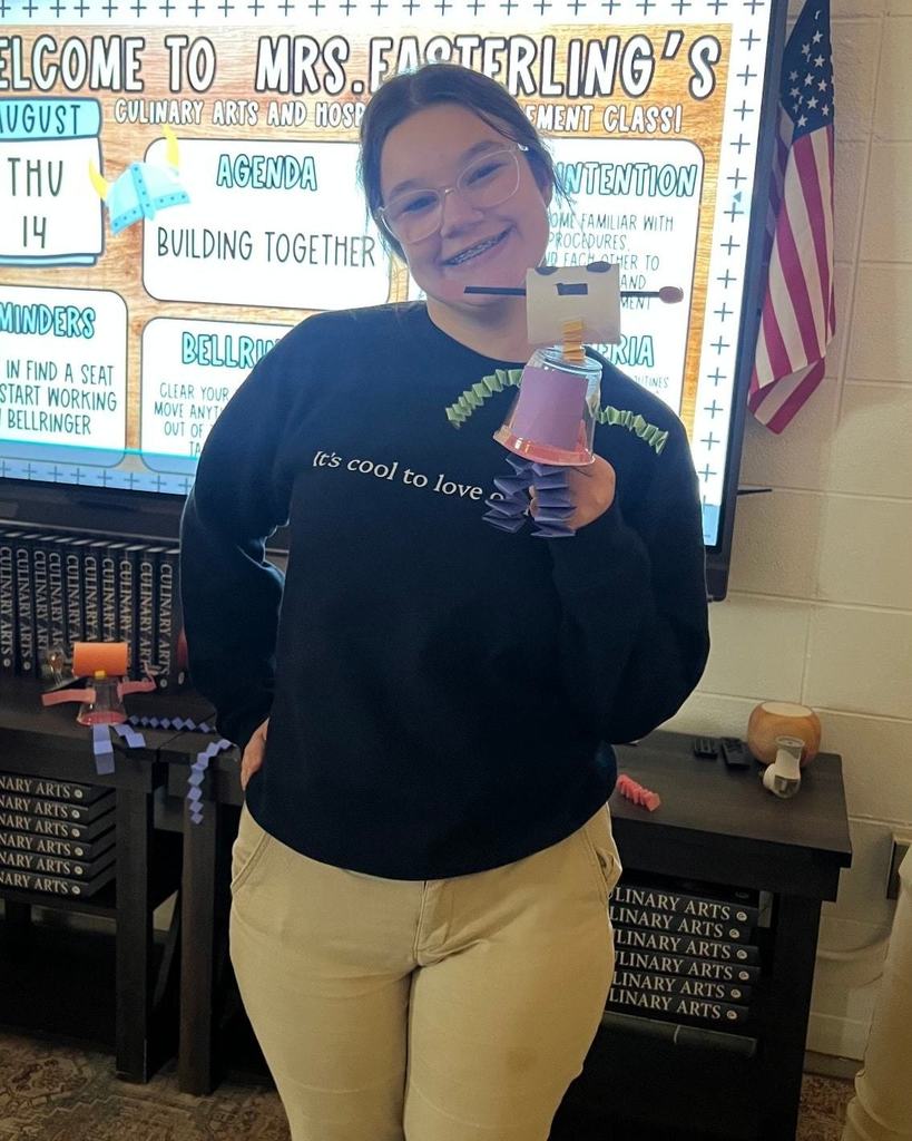 Student with a robot they created.