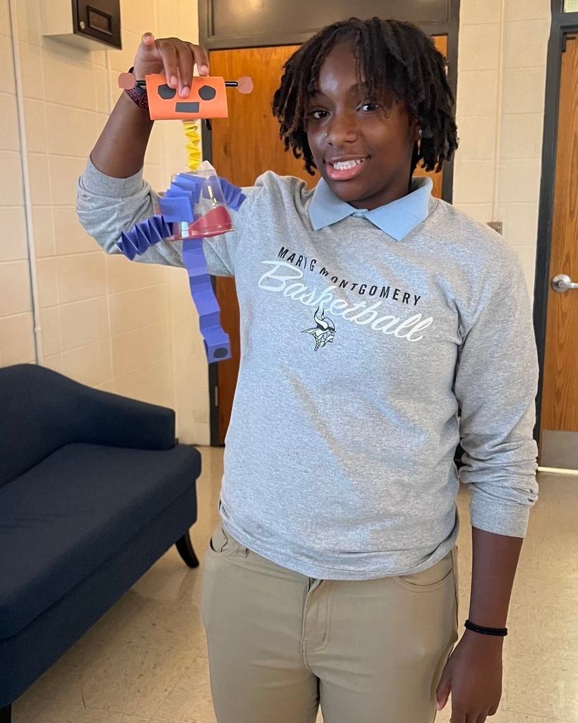 Student with a robot they created.