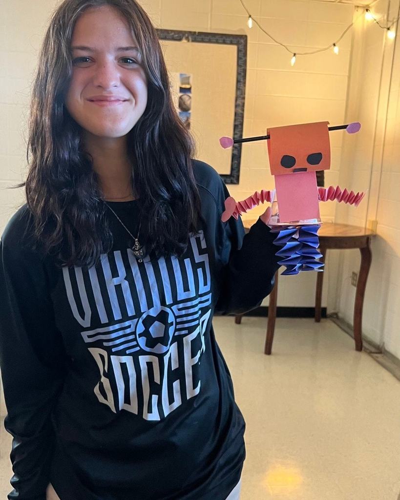Student with a robot they created.