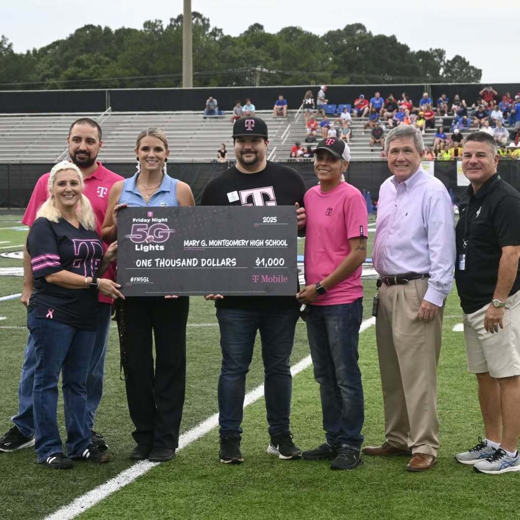 T-Mobile presenting a check for $1,000 to MGM.