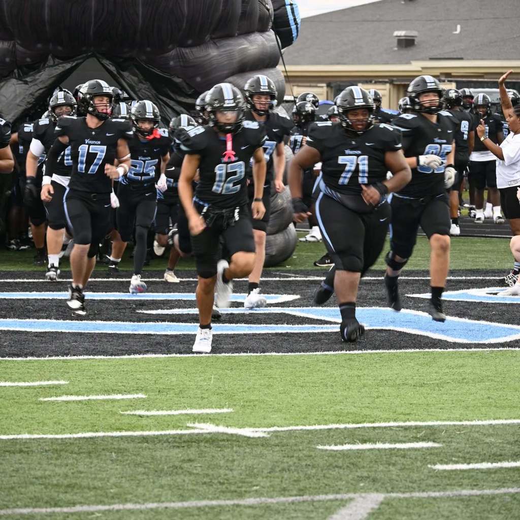 MGM Football team running on the field.