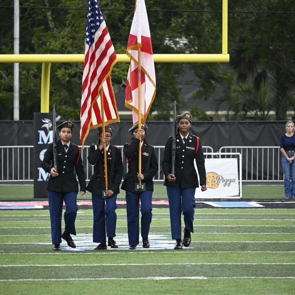 JROTC students marching on the field.