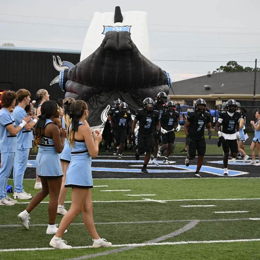 MGM Football team running on the field.