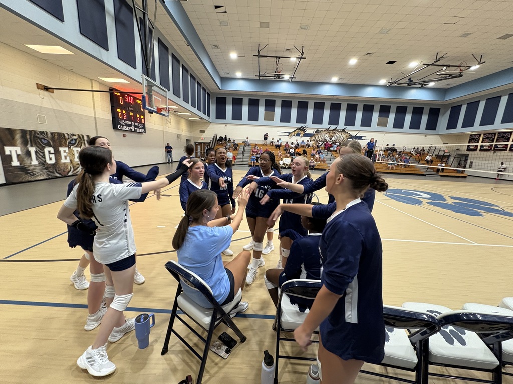Volleyball team chanting in a huddle