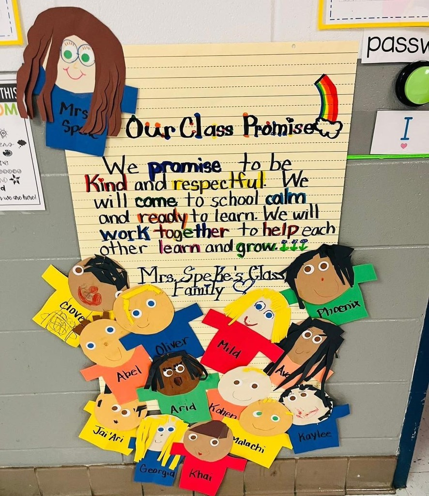 A "Classroom Promise" bulletin board with cutout drawings of each student