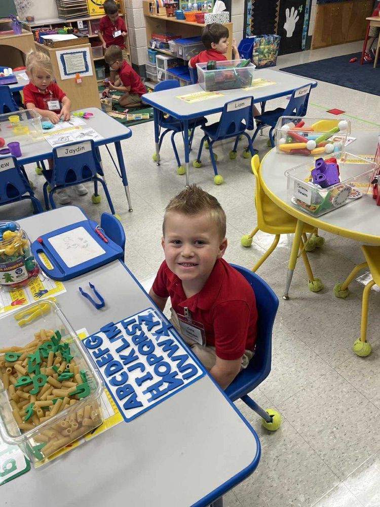 Pre K student working/playing in a center