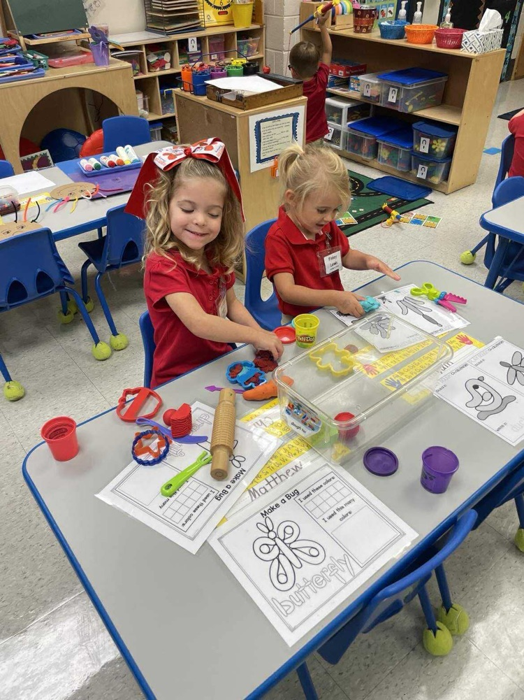 Pre K student working/playing in a center