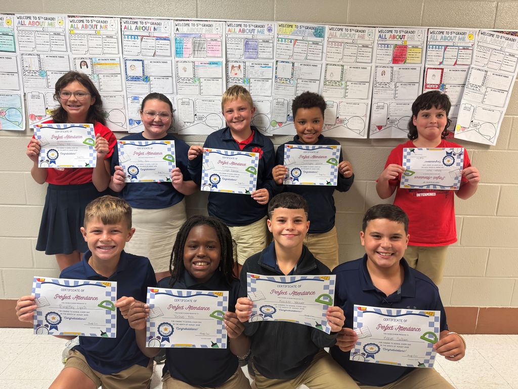 Ms.Lowe's class holding perfect attendance certificates for August.