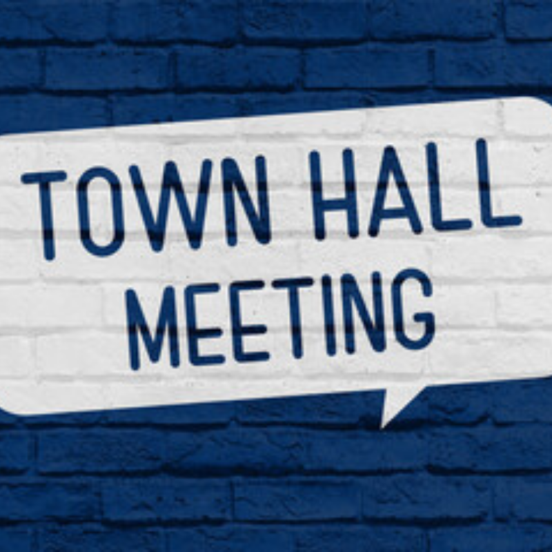 a brick wall with the words Town Hall Meeting painted on it