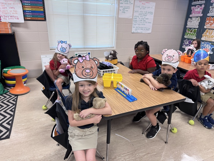 students holding teddy bears