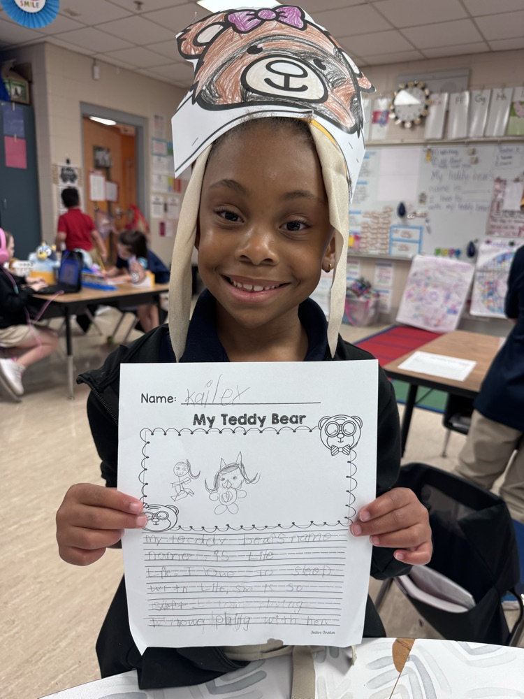 child holding up writing 