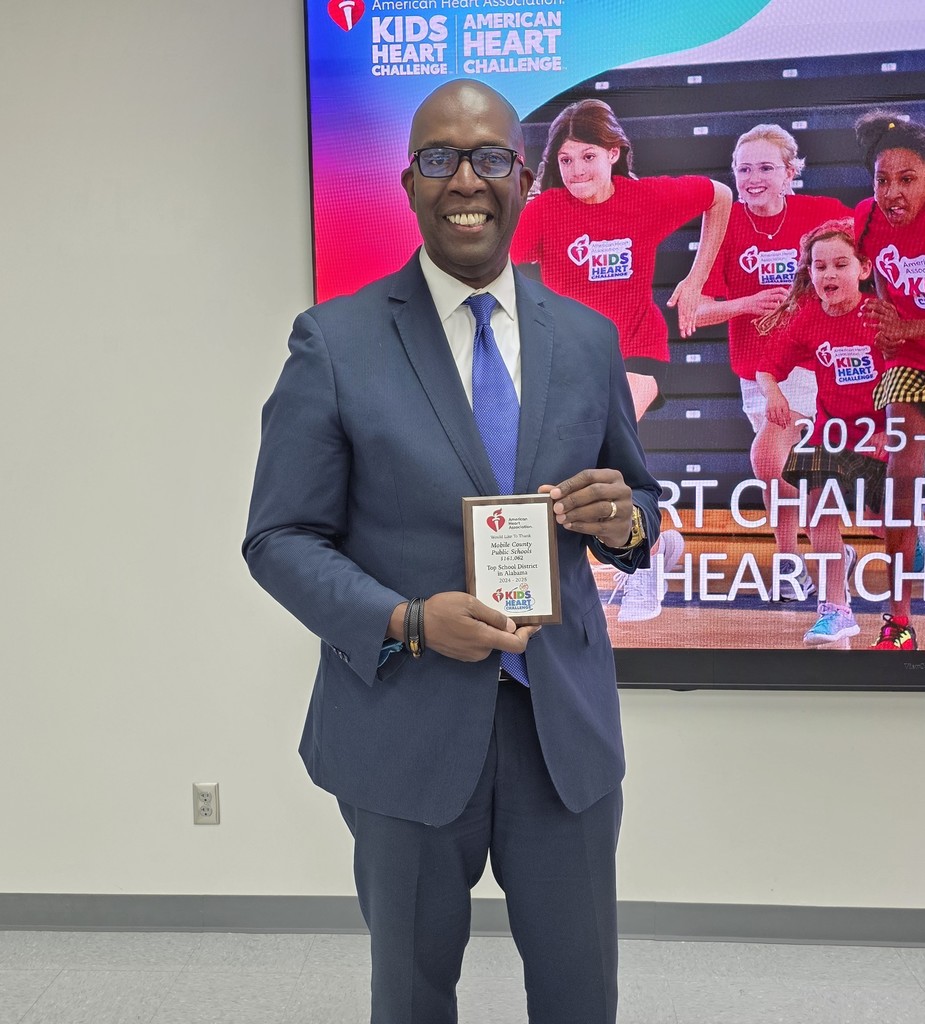 MCPSS Assistant Superintendent Terrance Mixon holding a plaque