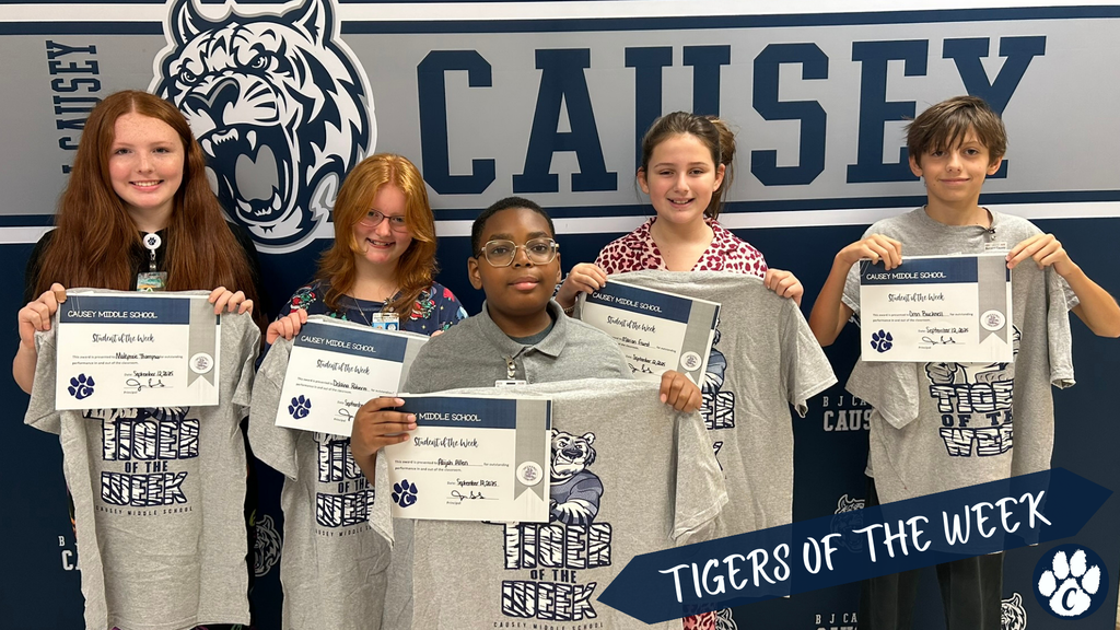 5 students holding up t-shirts and certificates