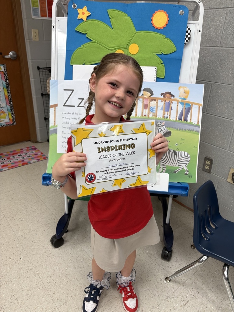 Mrs. Holland's student holding a certificate
