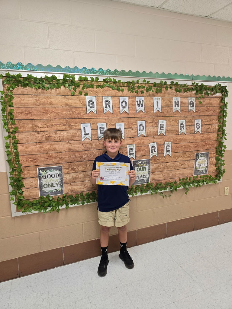 Mrs. Holland's student holding a certificate