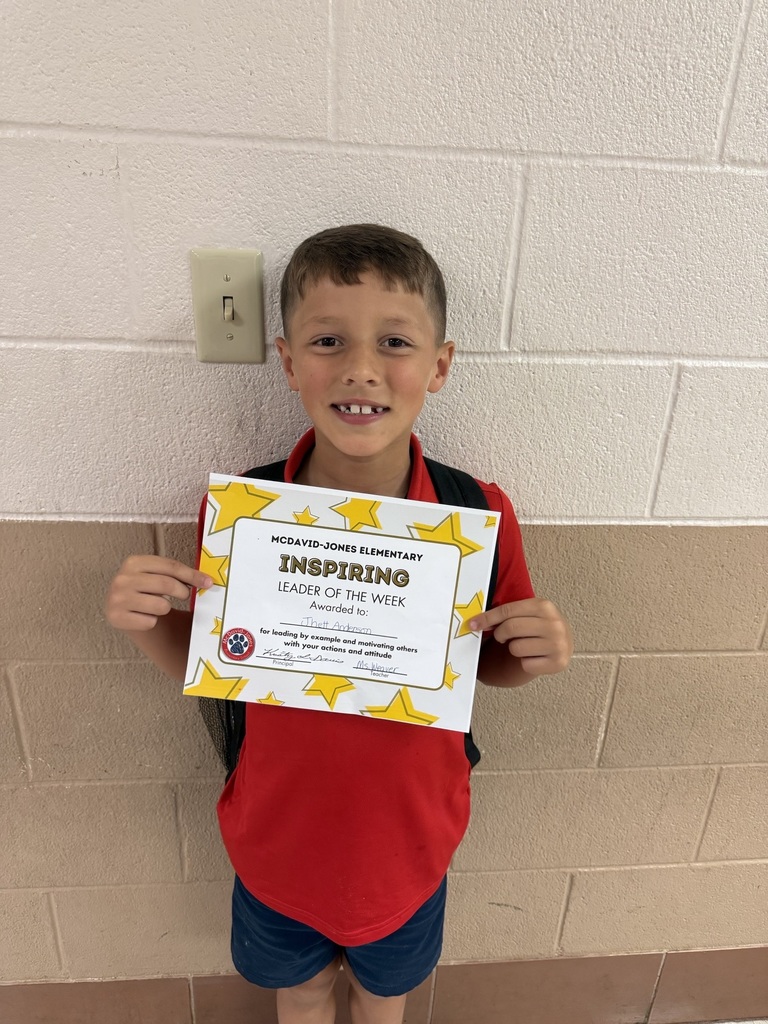 Ms. Weaver's student holding a certificate