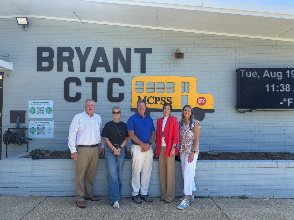 Five people standing in front of Bryant Career Technical Center
