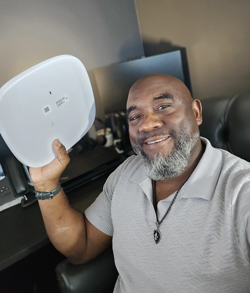 A man holding up an internet router