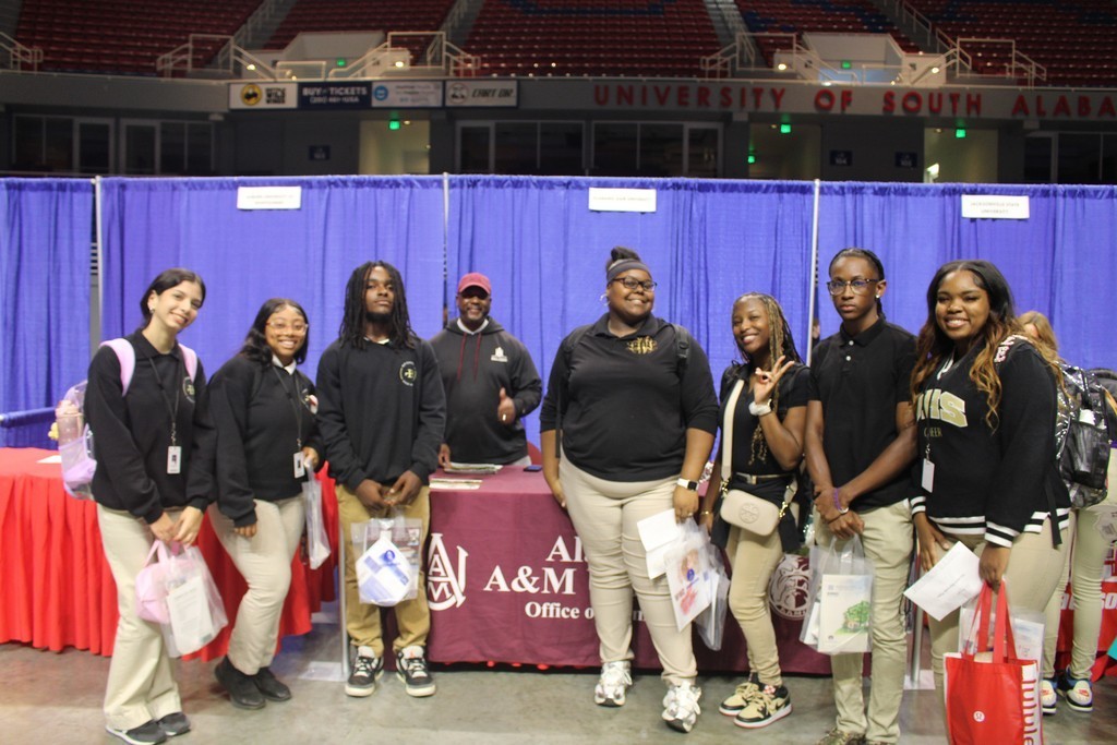 A group of students standing in front of the Alabama A&M table