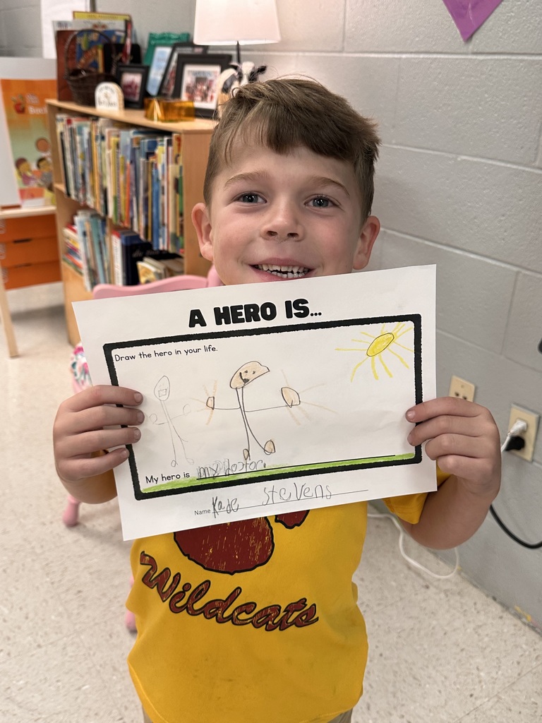 Student holding his paper about A hero is...