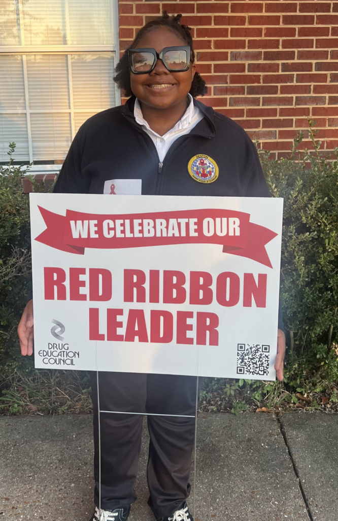 Kaci Payne  with Red Ribbon sign